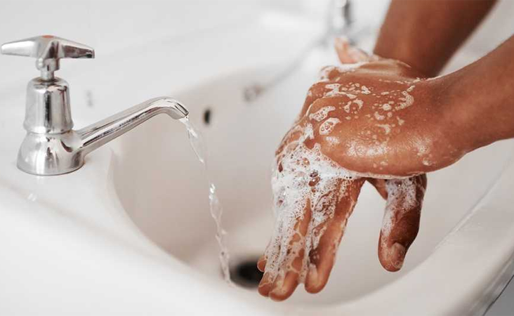 Person washing hands with soap