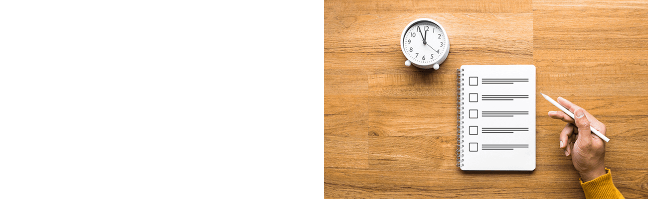 Clock and notepad checklist on desk