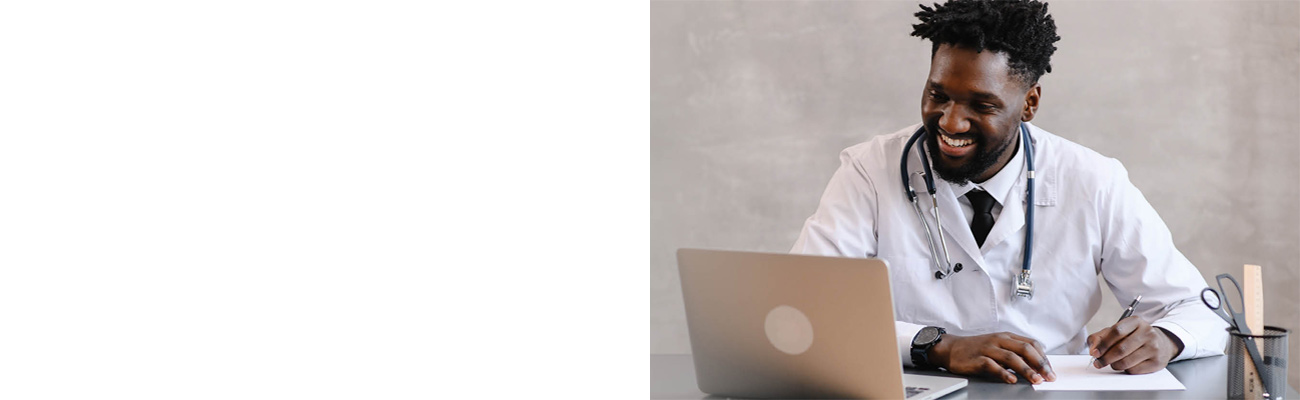Doctor smiling and looking at laptop screen