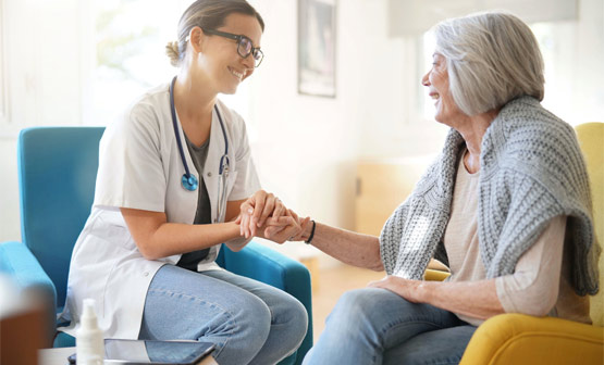 Doctor comforting older patient